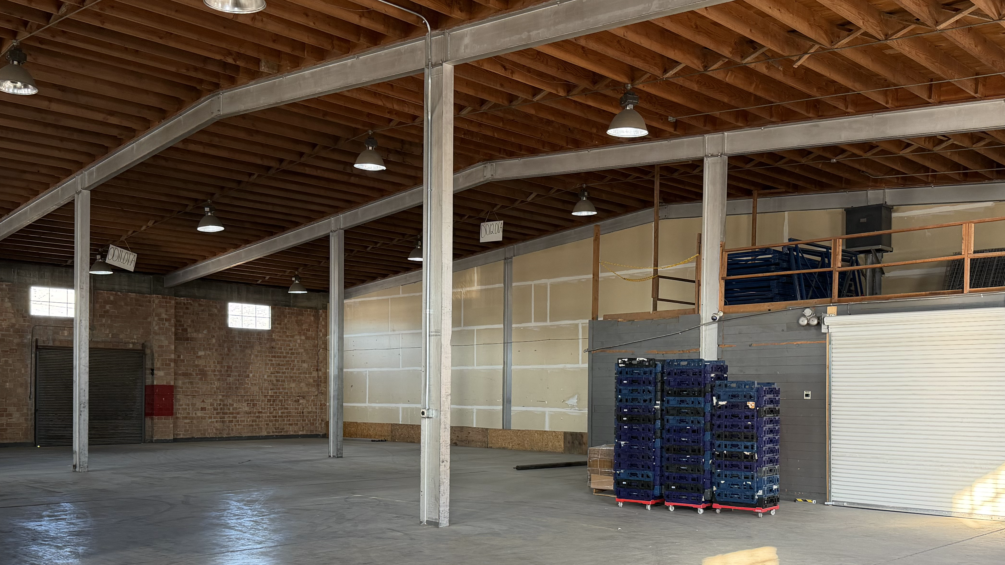 Interior crossdock bay with pallet stacks and a roll-up loading door